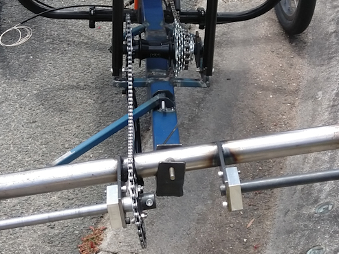 Rear driver of recumbent cargo quad using a single sprocket kinked to a mid drive